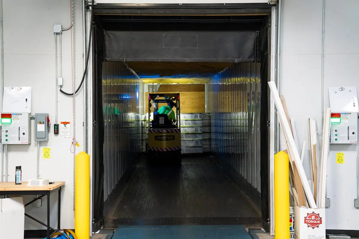 Forklift loading a 53-foot dry van trailer at the dock